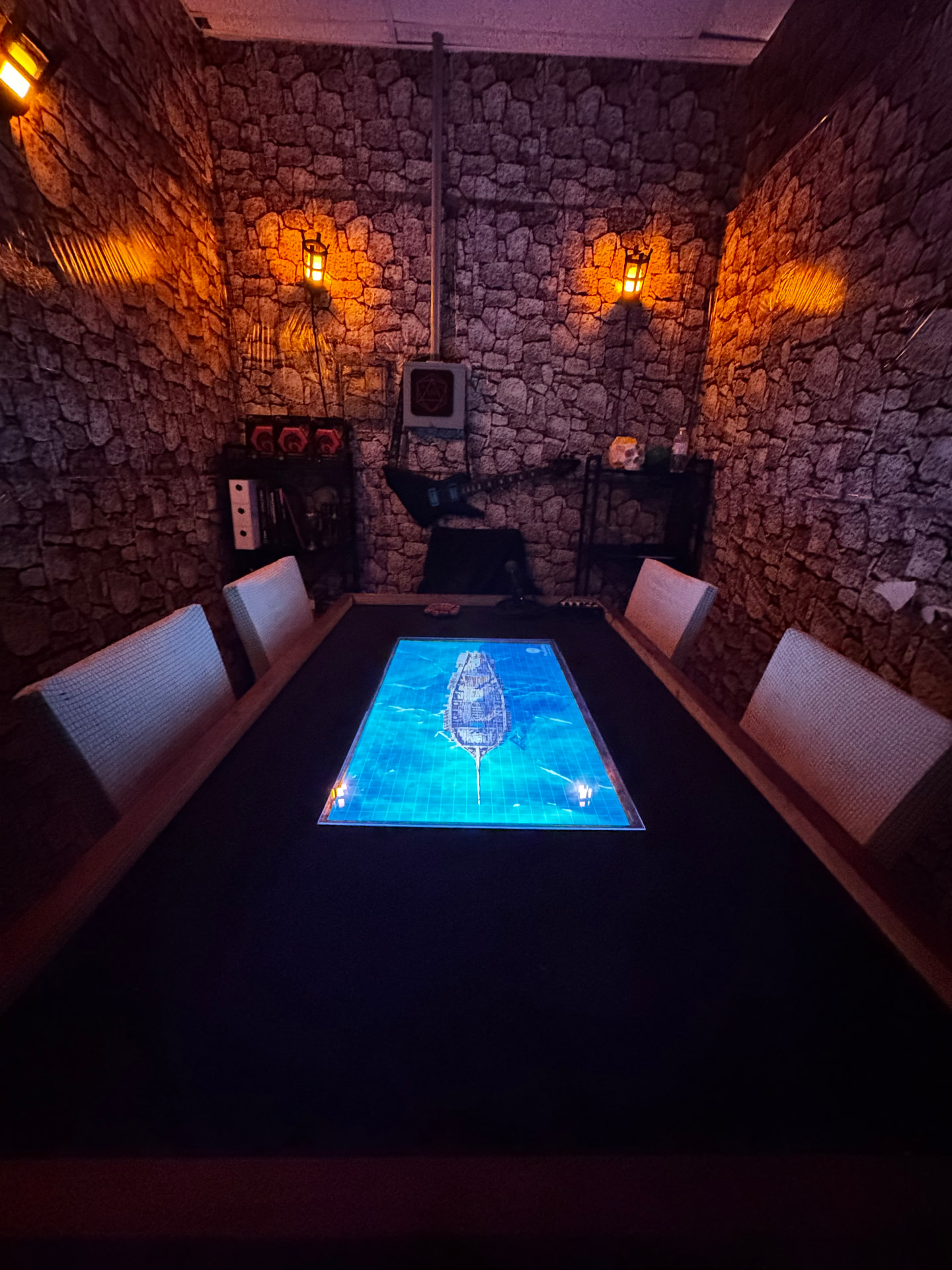 The dungeon table with a Foundry VTT battle map glowing on the built-in TV